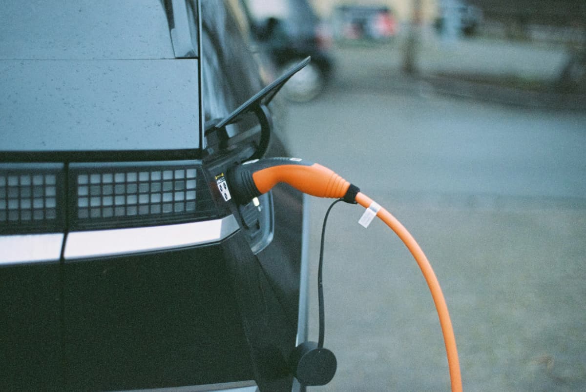 An EV being charged in a shared residential garage